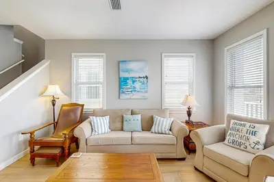 a living room with a couch and two chairs at Spacious Seabreeze Trail home with gulf views & shared pool - short walk to beach in Seacrest