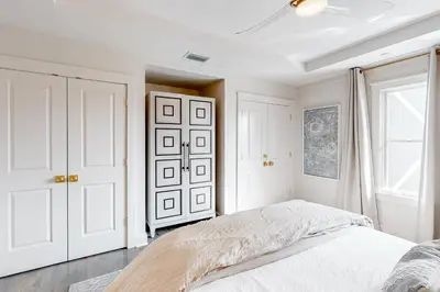 a white bedroom with a bed and a window at Gorgeous updated condo with balconies pool & great location near 30A in Watersound Beach