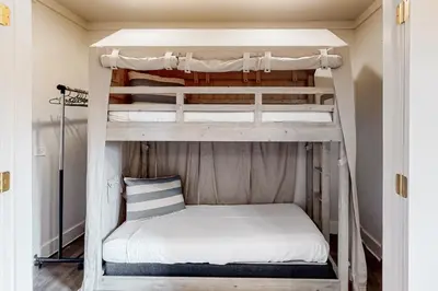 a bedroom with two bunk beds in a room at Gorgeous updated condo with balconies pool & great location near 30A in Watersound Beach