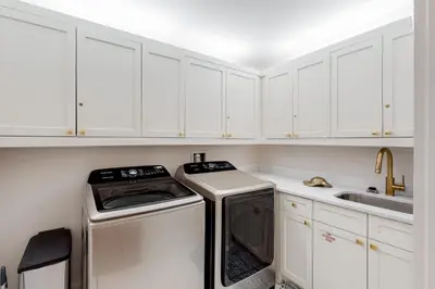 a kitchen with white cabinets and a dishwasher at Gorgeous updated condo with balconies pool & great location near 30A in Watersound Beach