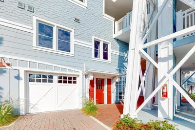 a house with a red and white garage at Gorgeous updated condo with balconies pool & great location near 30A in Watersound Beach