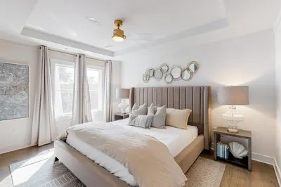 a white bedroom with a large bed and a window at Gorgeous updated condo with balconies pool & great location near 30A in Watersound Beach