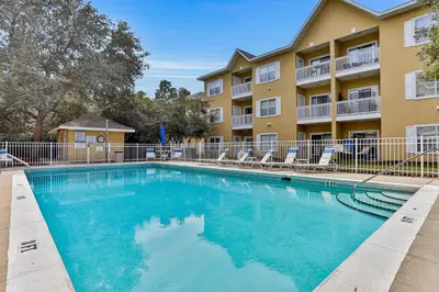 a swimming pool in front of a apartment building at Pool-view condo with private balcony washer and dryer Wifi in Santa Rosa Beach