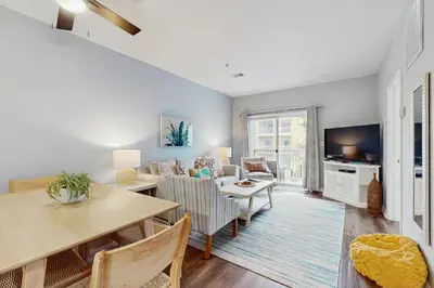 a living room with a table and a dining room at Pool-view condo with private balcony washer and dryer Wifi in Santa Rosa Beach