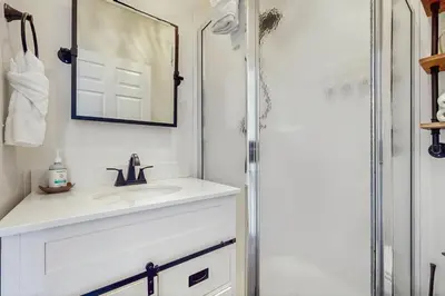 a white bathroom with a sink and a shower at Pool-view condo with private balcony AC & washer&dryer in Santa Rosa Beach