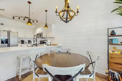 a dining room with a wooden table and chairs at Pool-view condo with private balcony AC & washer&dryer in Santa Rosa Beach