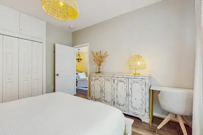 a bedroom with a bed and a desk and a chair at Pool-view condo with private balcony AC & washer&dryer in Santa Rosa Beach