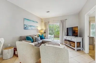 a living room with a couch and a tv at Comfortable coastal house with roomy accommodations and easy shoreline access in Santa Rosa Beach