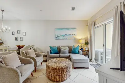 a living room with a couch and chairs and a table at Comfortable coastal house with roomy accommodations and easy shoreline access in Santa Rosa Beach