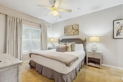 a bedroom with a bed and a ceiling fan at Comfortable coastal house with roomy accommodations and easy shoreline access in Santa Rosa Beach