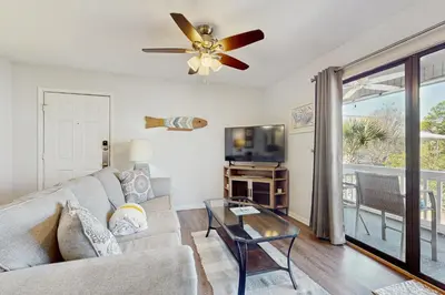 a living room with a couch and a ceiling fan at Cozy coastal condo dog friendly with shared pool and close to beach in Santa Rosa Beach