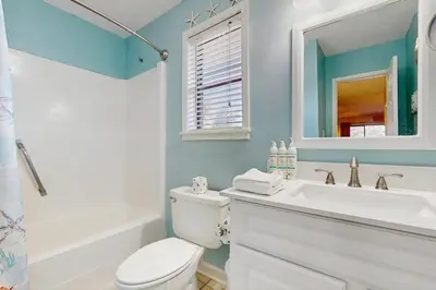 a bathroom with a white toilet and a sink at Cozy coastal condo dog friendly with shared pool and close to beach in Santa Rosa Beach
