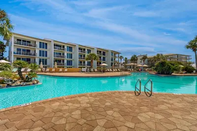a swimming pool at a resort with blue water at Open-concept beachfront home with balcony lagoon pool beach access pickleball in Seacrest