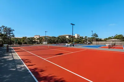 a tennis court with two tennis courts at Open-concept beachfront home with balcony lagoon pool beach access pickleball in Seacrest