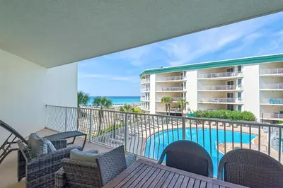 a balcony with a view of the pool and the ocean at Lovely waterfront condo with balcony pool hot tub & pickleball in Santa Rosa Beach