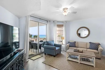 a living room with a couch and a tv at Lovely waterfront condo with balcony pool hot tub & pickleball in Santa Rosa Beach