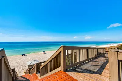 a view of the beach from the deck of a beach house at Beach haven with patio lagoon pool hot tub & pickleball - walk to beach in Seacrest