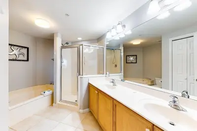 a bathroom with two sinks and a shower at Lovely condo with pool hot tub ocean views & pickleball in Santa Rosa Beach