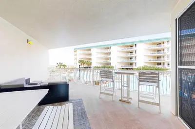 a room with a balcony with a table and chairs at Lovely condo with pool hot tub ocean views & pickleball in Santa Rosa Beach