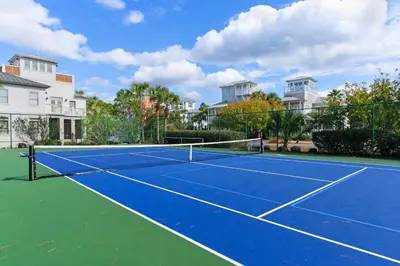 a tennis court in front of some houses at Lovely condo with pool hot tub ocean views & pickleball in Santa Rosa Beach