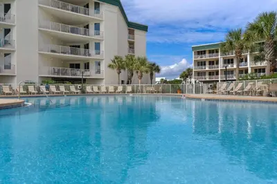 a large swimming pool in front of a building at Lovely condo with pool hot tub ocean views & pickleball in Santa Rosa Beach