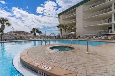 a swimming pool in front of a hotel at Lovely condo with pool hot tub ocean views & pickleball in Santa Rosa Beach
