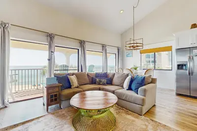 a living room with a couch and a table at Ideally located beachfront home with balcony washer&dryer AC & amazing views in Seacrest
