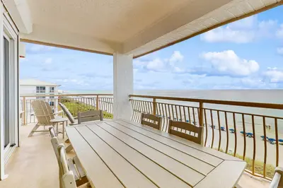 a balcony with a view of the ocean at Lavish High Pointe condo with resort pool amazing ocean view & pickleball in Seacrest
