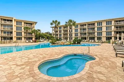 a swimming pool in front of a large apartment building at Water-view condo with pool hot tub & pickleball in Rosemary Beach