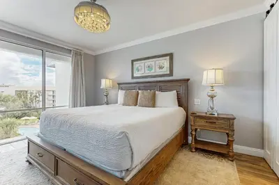 a bedroom with a bed and a large window at Water-view condo with pool hot tub & pickleball in Rosemary Beach