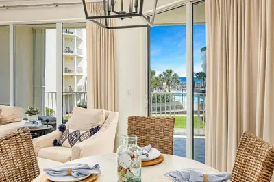 a dining room with a view of the ocean at Chic first-floor condo with Gulf & pool view & pickleball - steps to beach in Santa Rosa Beach