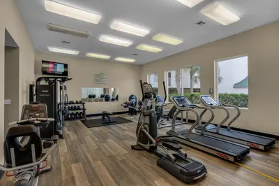a gym with several treadmills and elliptical machines at Chic first-floor condo with Gulf & pool view & pickleball - steps to beach in Santa Rosa Beach