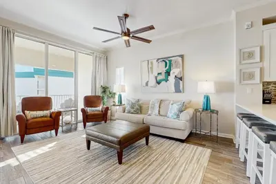 a living room with a couch and a ceiling fan at Luxe Beachfront Resort Condo with Private Beach Access & Top Amenities in Santa Rosa Beach