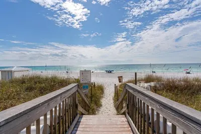 a boardwalk leading to the beach with the ocean at Luxe Beachfront Resort Condo with Private Beach Access & Top Amenities in Santa Rosa Beach