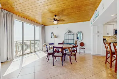 a kitchen and dining room with a table and chairs at Gulf front condo with beach access pool hot tub tennis & pickleball in Seacrest