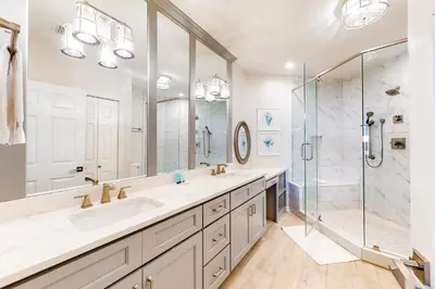a bathroom with two sinks and a shower at Stunning 4th-floor condo with pool tennis pickleball ocean & beach view in Santa Rosa Beach