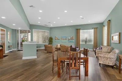 a living room with a table and chairs at Stunning 4th-floor condo with pool tennis pickleball ocean & beach view in Santa Rosa Beach