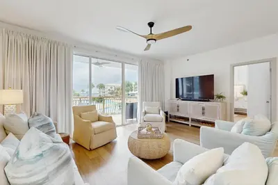 a living room with white furniture and a flat screen tv at 2nd-floor condo with beach access pool tennis pickleball hot tub balcony in Seacrest