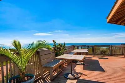 a wooden deck with a table and benches on the beach at 2nd-floor condo with beach access pool tennis pickleball hot tub balcony in Seacrest