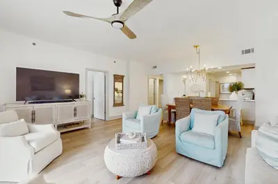 a living room with white furniture and a dining room at 2nd-floor condo with beach access pool tennis pickleball hot tub balcony in Seacrest