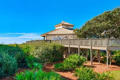 a large house with a tower on top of a hill at 2nd-floor condo with beach access pool tennis pickleball hot tub balcony in Seacrest