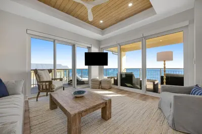a living room with a view of the ocean at Luxuriously renovated condo with Gulf views beach access pool & hot tub in Inlet Beach