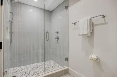 a bathroom with a shower with a glass door at Luxuriously renovated condo with Gulf views beach access pool & hot tub in Inlet Beach