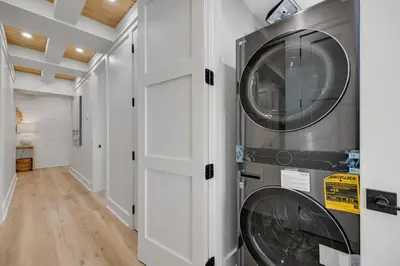 a laundry room with a washer and dryer at Luxuriously renovated condo with Gulf views beach access pool & hot tub in Inlet Beach