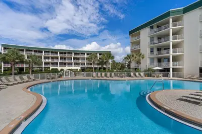 a swimming pool in front of a resort at Beach-view condo with outdoor pool hot tub sauna tennis BBQ & beach access in Santa Rosa Beach