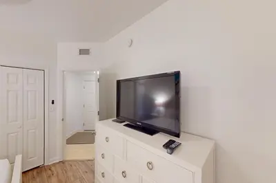 a flat screen tv sitting on top of a dresser at Coastal condo with beach pool hot tub sauna tennis bikes W&D & central AC in Santa Rosa Beach
