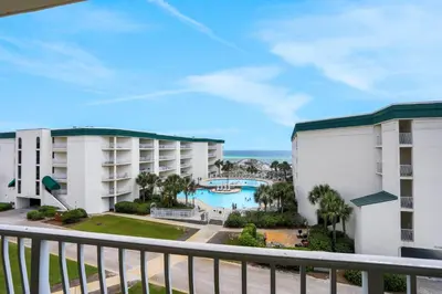 a view of the pool from the balcony of a resort at Dunes of Seagrove condo with pool hot tub sauna gym & tennis pickleball in Santa Rosa Beach