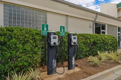 a row of parking meters in front of a building at Ground floor beachfront condo with shared pool and beach access in Santa Rosa Beach