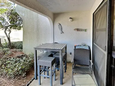 a table and chairs sitting on a porch at Edgewater Villa #2001 in Panama City Beach