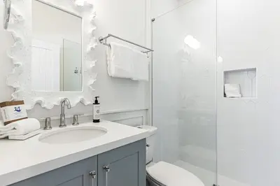a white bathroom with a sink and a shower at Fin and Tonic - Magnolia Cottages 3 BR, Heated Community Pool, Bikes in Inlet Beach